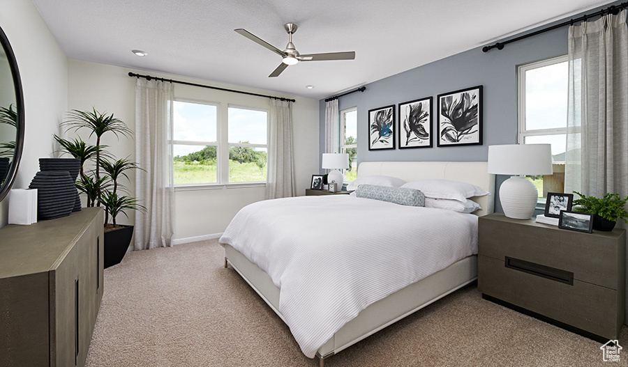 Bedroom featuring baseboards, recessed lighting, light carpet, and ceiling fan