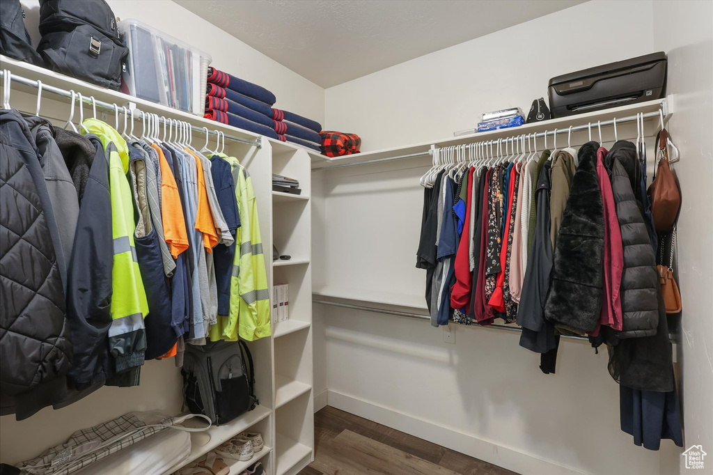 Walk in closet featuring wood finished floors