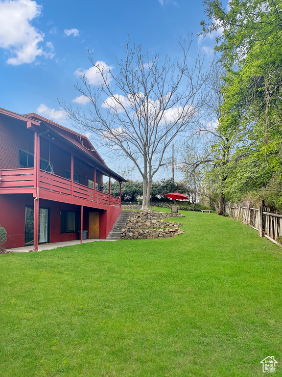 View of yard with a patio and fence