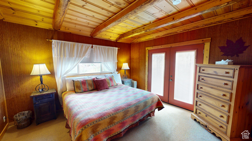 Bedroom with french doors, light carpet, multiple windows, and wooden ceiling
