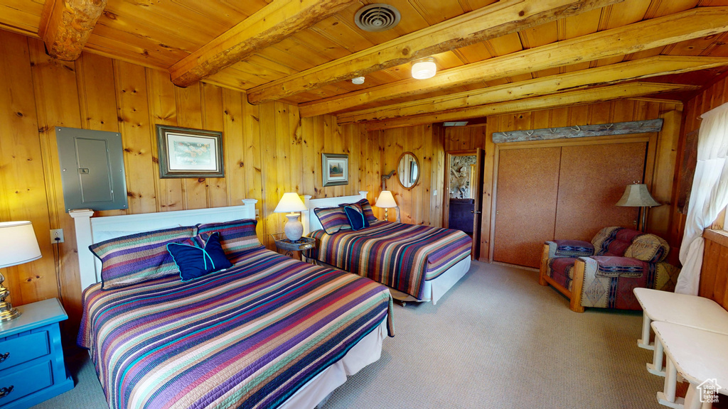 Bedroom featuring beam ceiling, carpet, wooden ceiling, visible vents, and electric panel