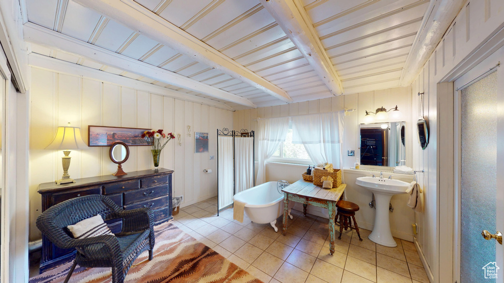 Full bathroom featuring tile patterned flooring, a soaking tub, and beamed ceiling
