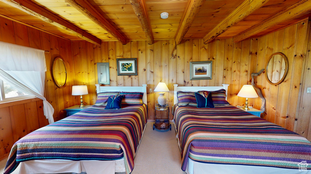 Carpeted bedroom with wood ceiling, wood walls, and beam ceiling