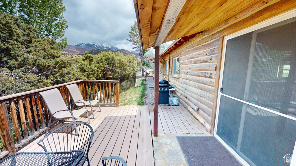 Wooden terrace featuring a mountain view and grilling area