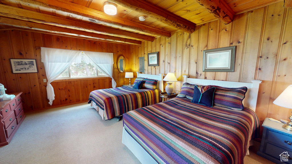 Bedroom featuring wooden walls, beamed ceiling, wooden ceiling, and carpet floors