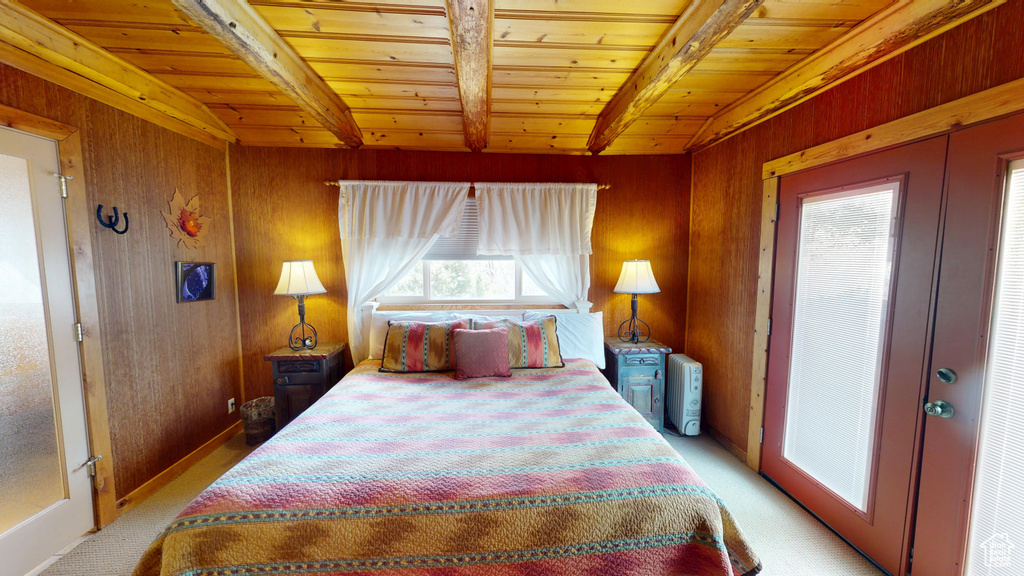 Bedroom featuring wood ceiling, light carpet, and beam ceiling
