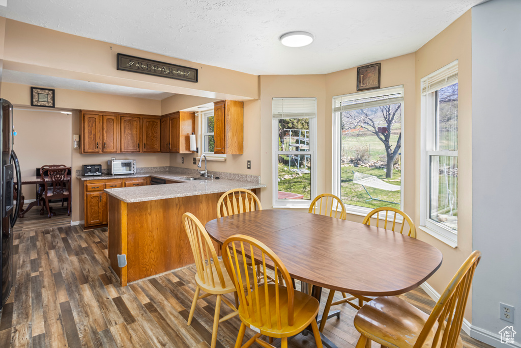 Dining space featuring dark wood finished floors and baseboards