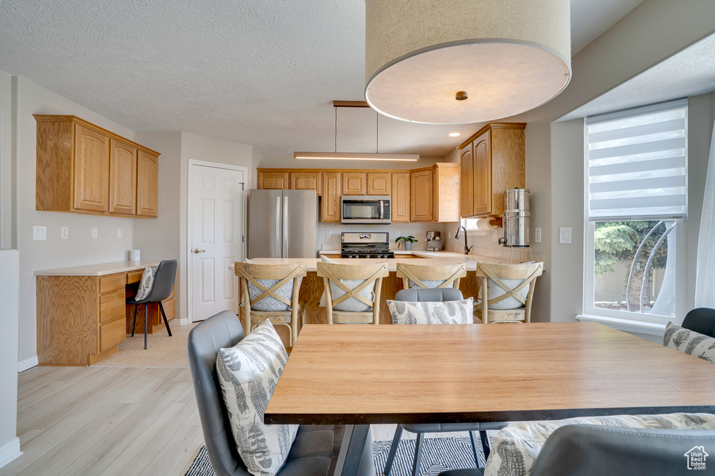 Dining room with light wood finished floors and baseboards