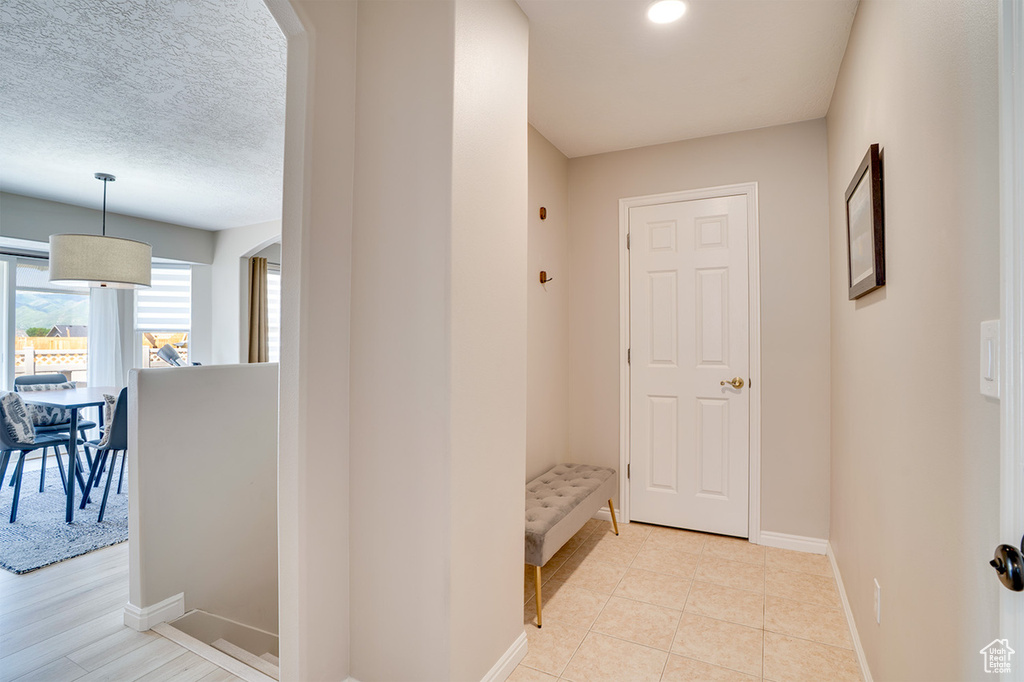Corridor featuring baseboards and arched walkways