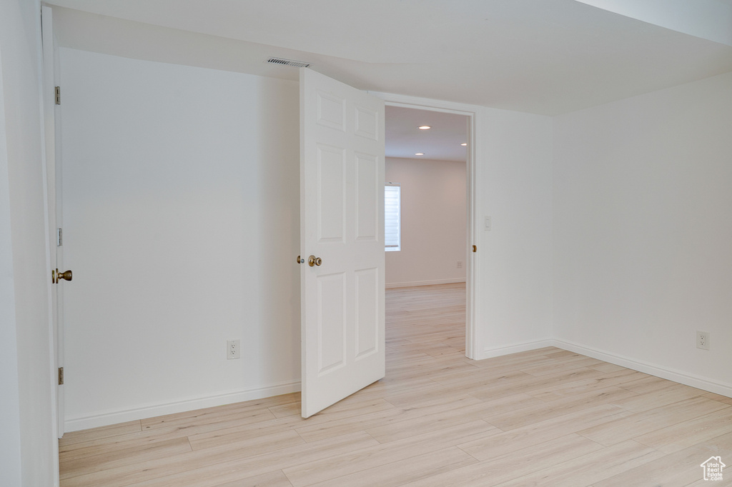 Unfurnished room with light wood-style flooring, recessed lighting, and baseboards