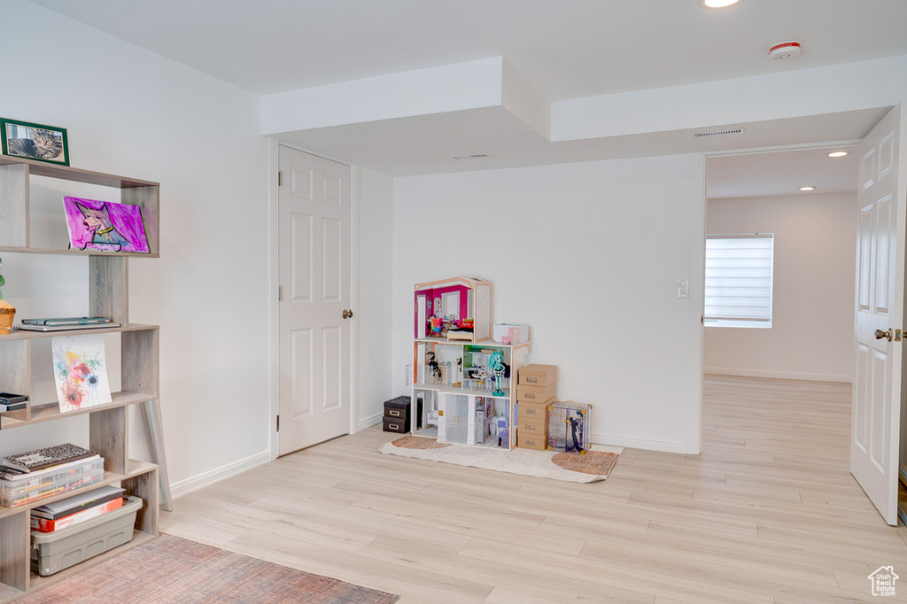 Game room with wood finished floors, baseboards, and recessed lighting