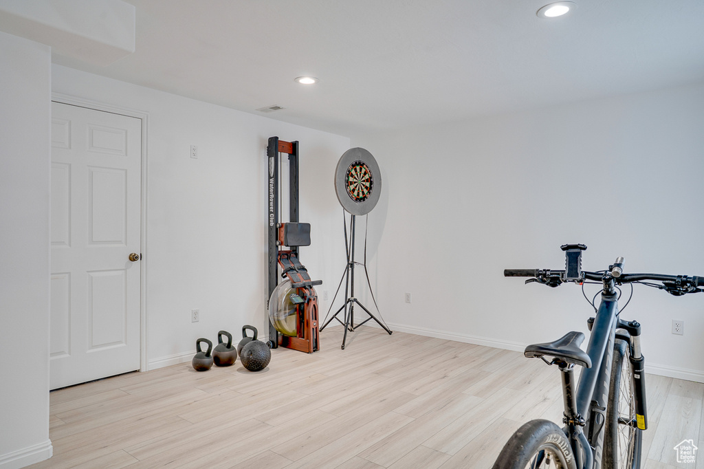 Exercise room with wood finished floors, recessed lighting, and baseboards