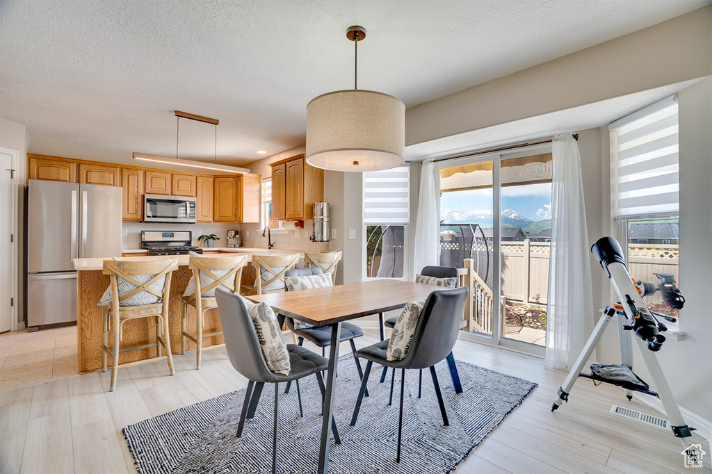 Dining area featuring light wood-style floors