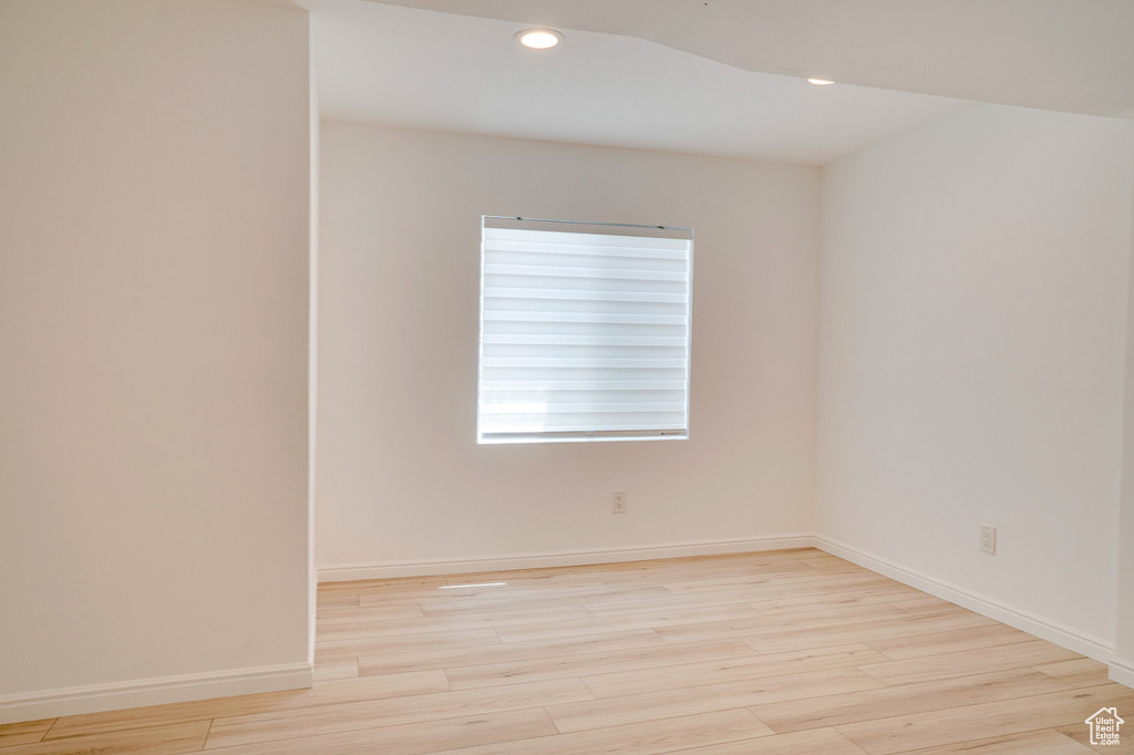 Unfurnished room with light wood-style flooring, recessed lighting, and baseboards