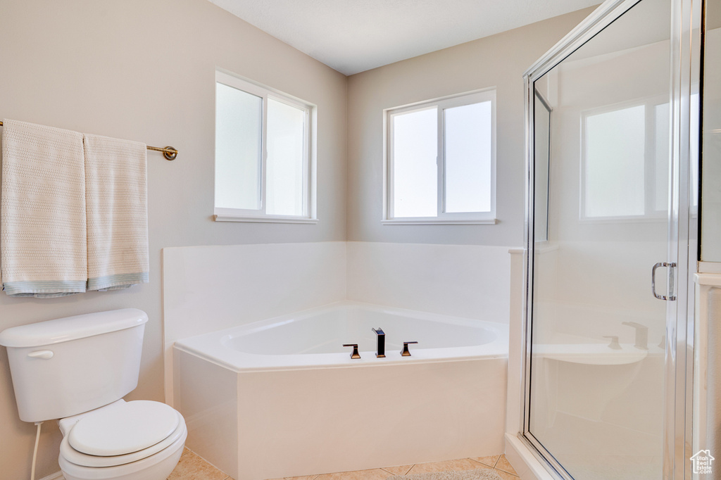 Full bathroom with toilet, a garden tub, a stall shower, and tile patterned flooring