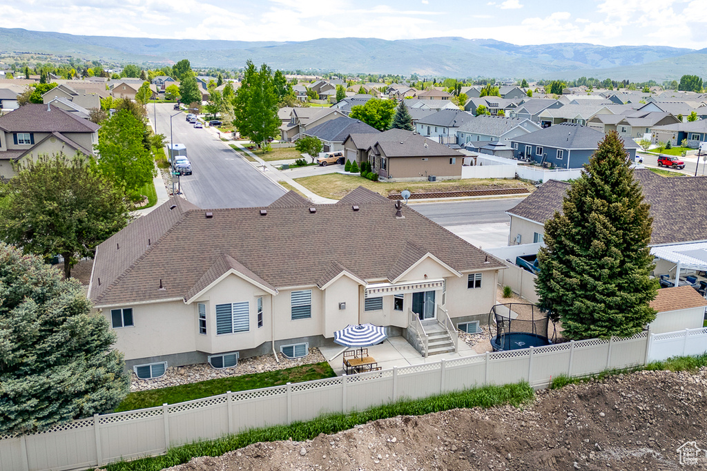 Aerial perspective of suburban area with a mountainous background