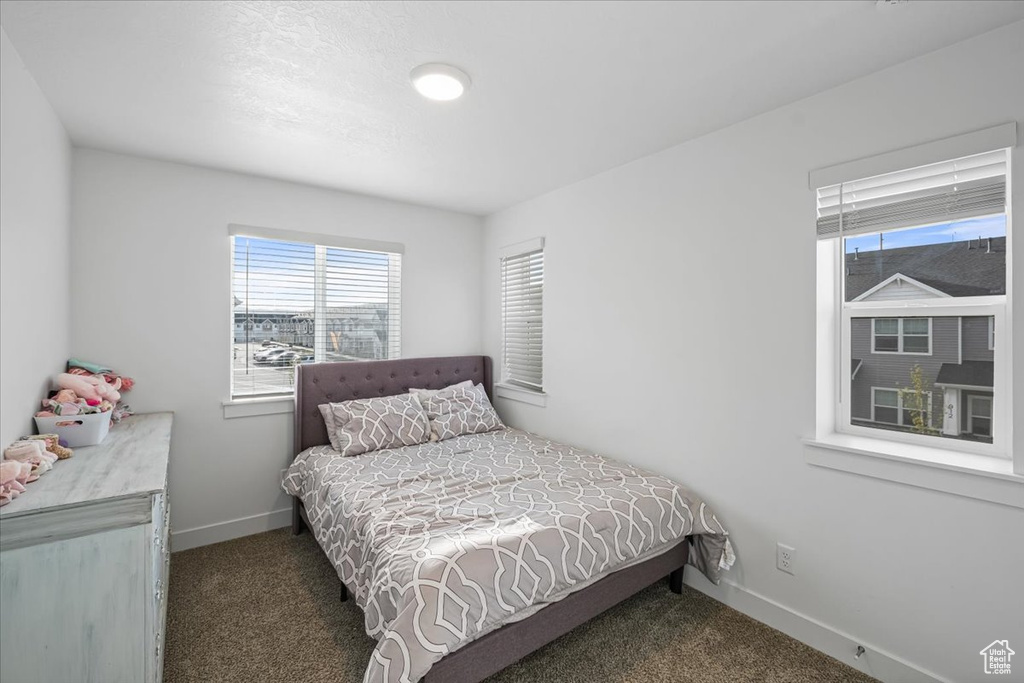 Carpeted bedroom featuring baseboards
