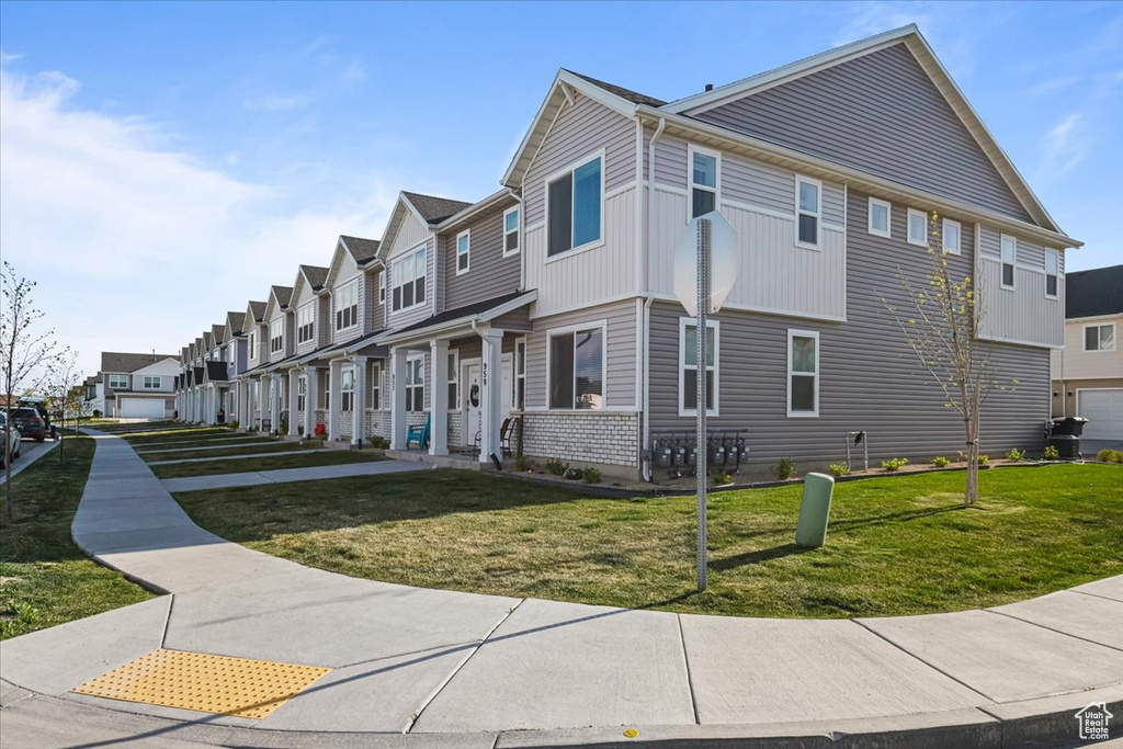 View of home's exterior featuring a residential view and a yard