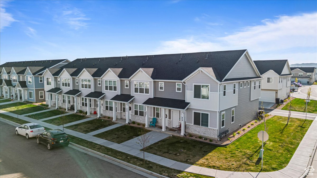 View of front of property featuring a residential view and a front yard