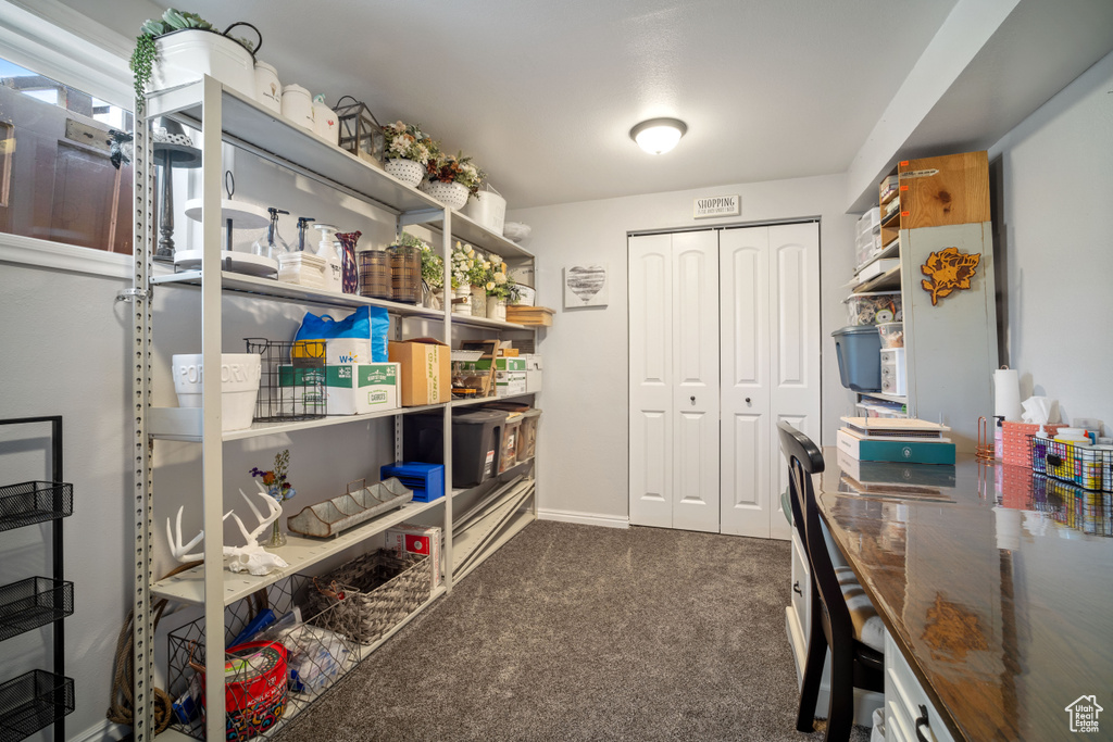Carpeted office space with baseboards