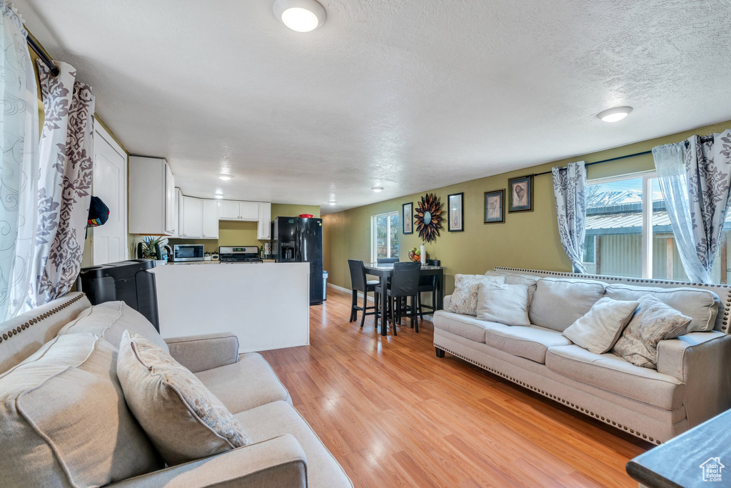 Living room featuring a textured ceiling and light wood-type flooring