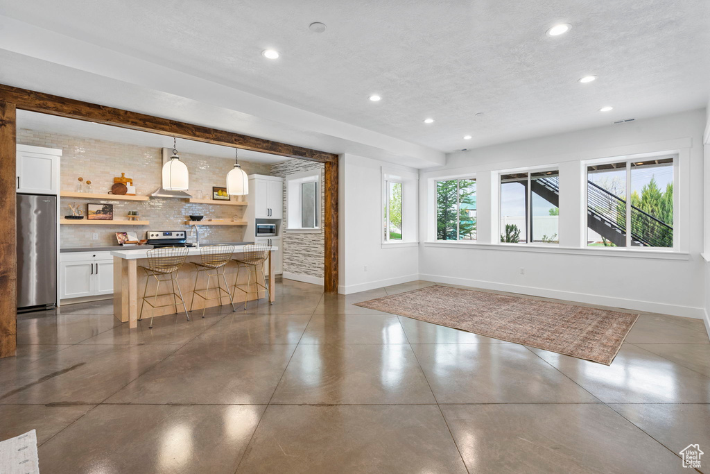 Interior space with baseboards and recessed lighting