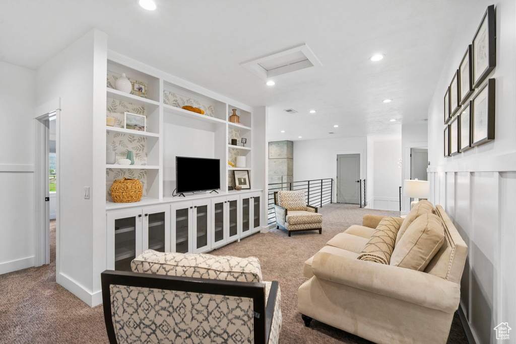 Carpeted living area featuring attic access, visible vents, recessed lighting, and baseboards