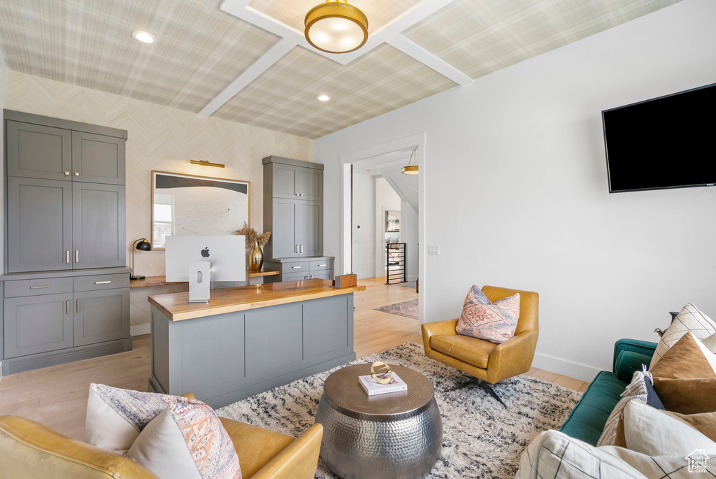 Living area with baseboards, light wood-type flooring, and wallpapered walls