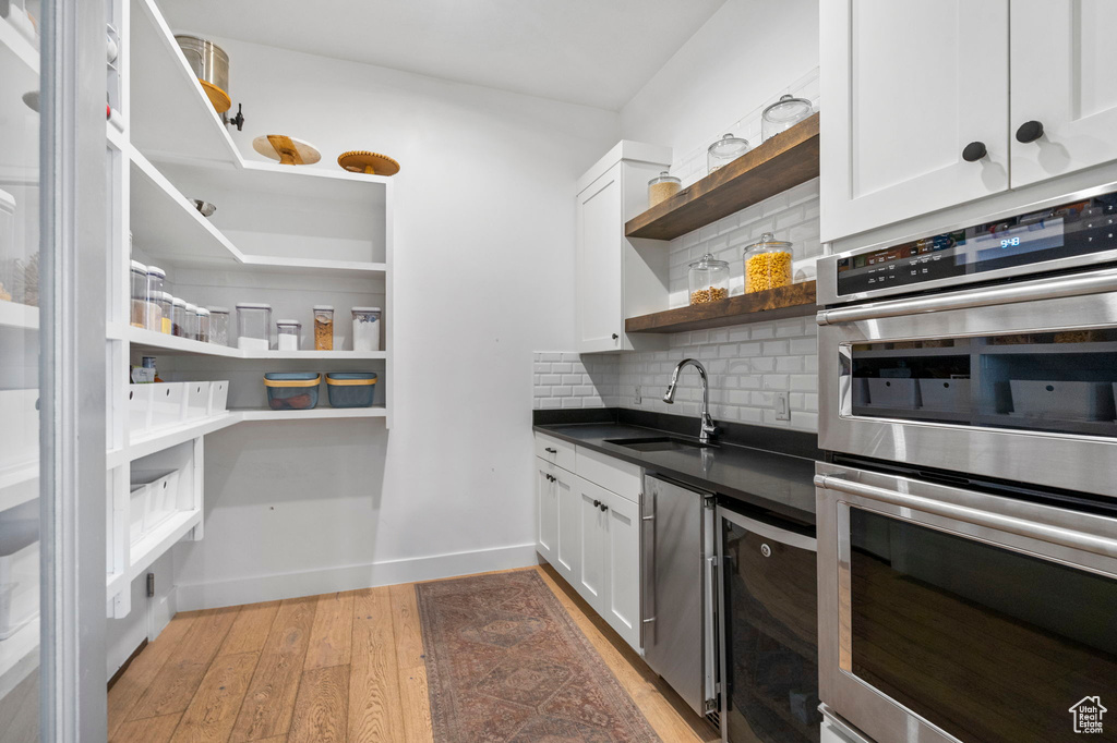 Storage area featuring a sink and beverage cooler