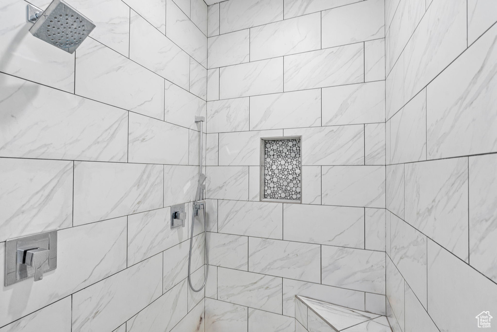 Full bath featuring a tile shower