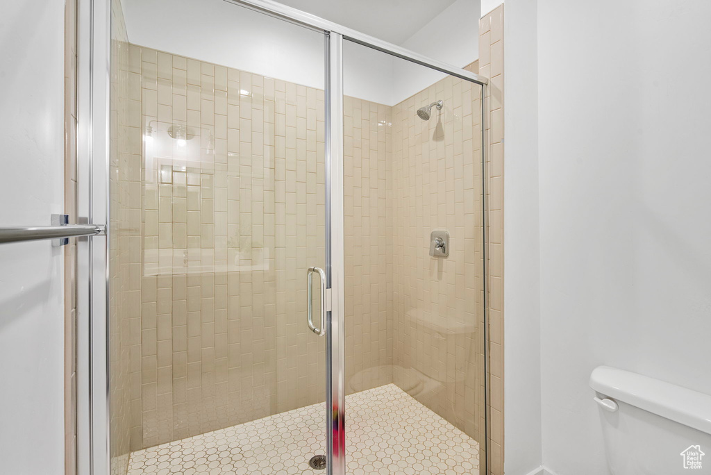 Bathroom with toilet and a stall shower