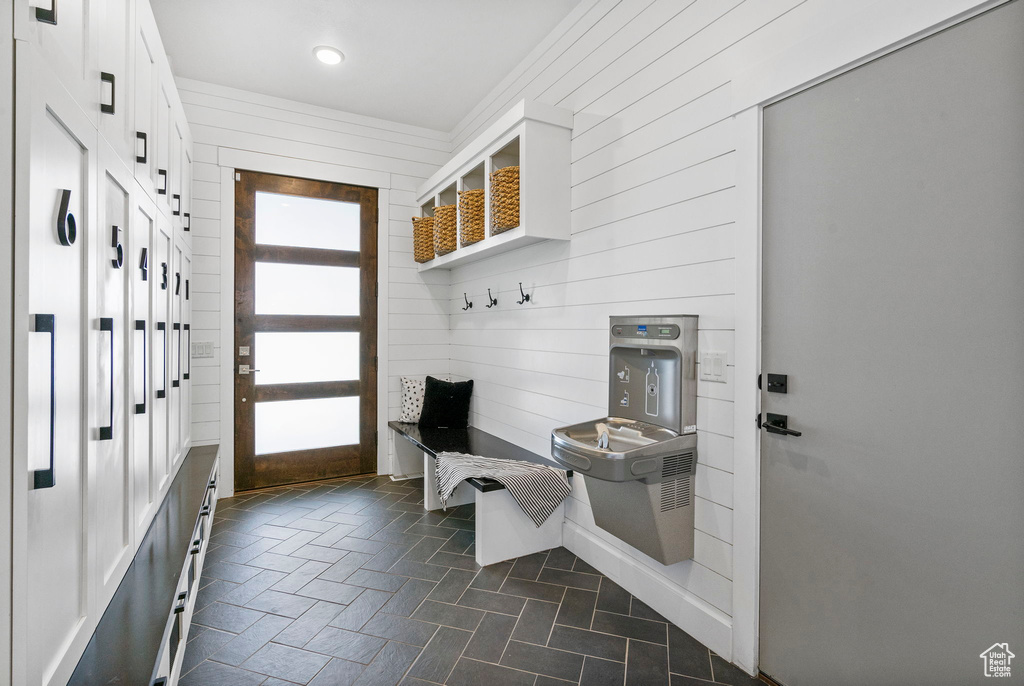 Mudroom with recessed lighting and wooden walls