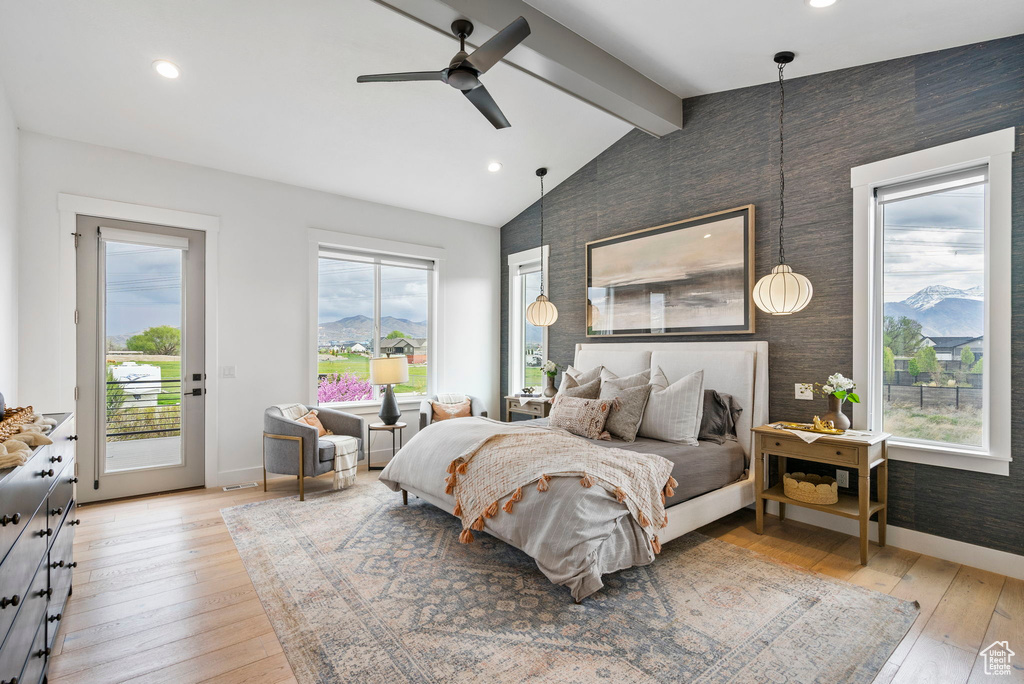 Bedroom with lofted ceiling with beams, baseboards, wallpapered walls, and access to outside