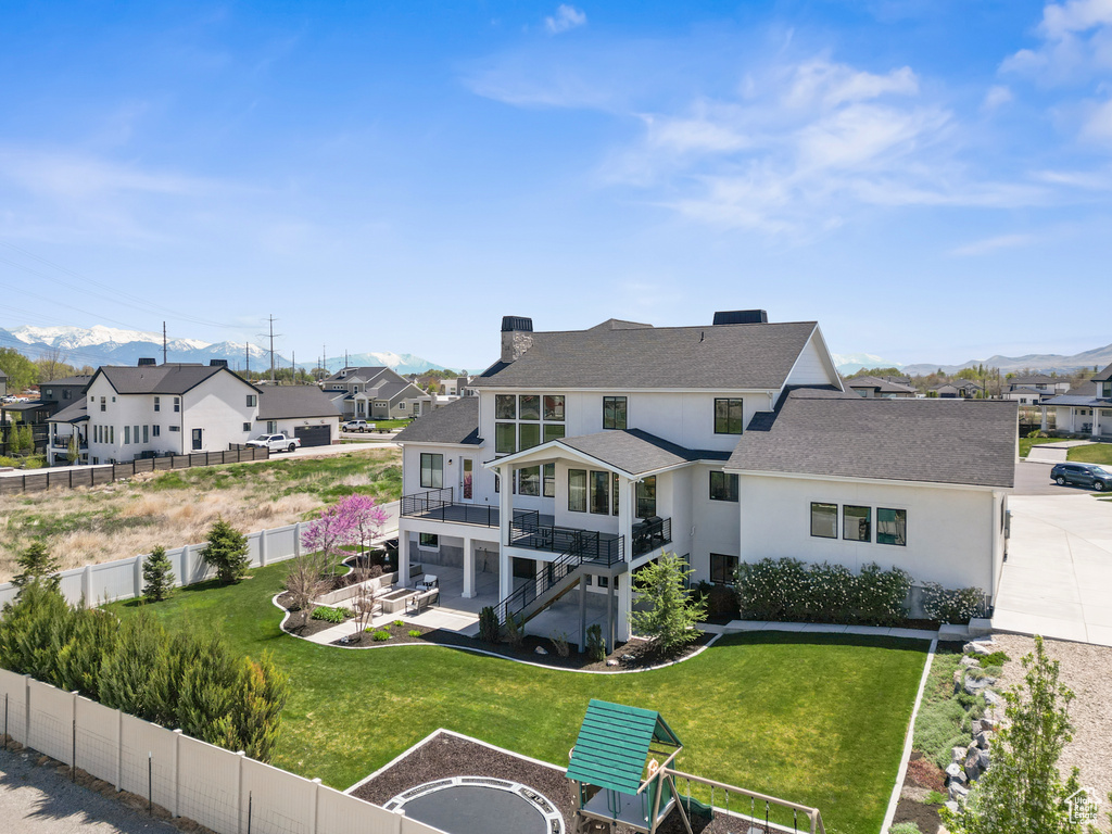 Rear view of property featuring a residential view, a fenced backyard, and a chimney