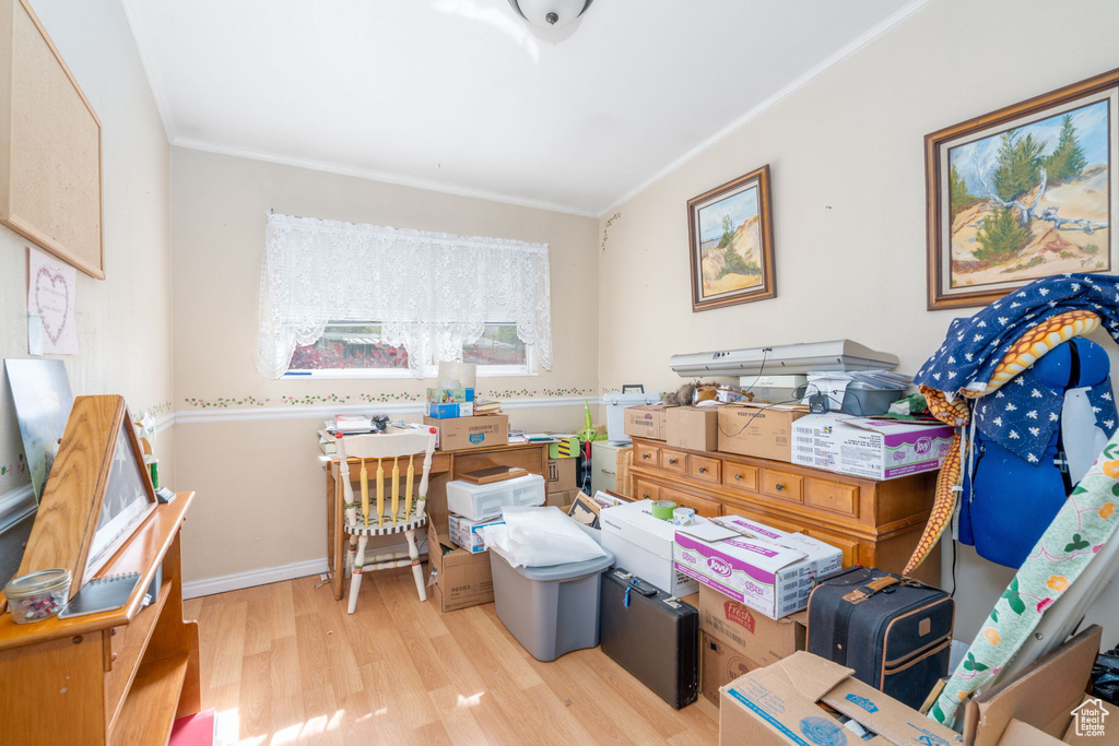 Interior space featuring ornamental molding, wood finished floors, and baseboards