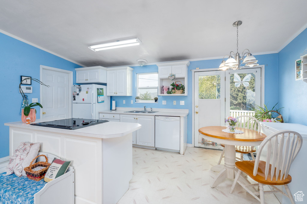 Kitchen featuring crown molding, white cabinets, a sink, light countertops, and white appliances