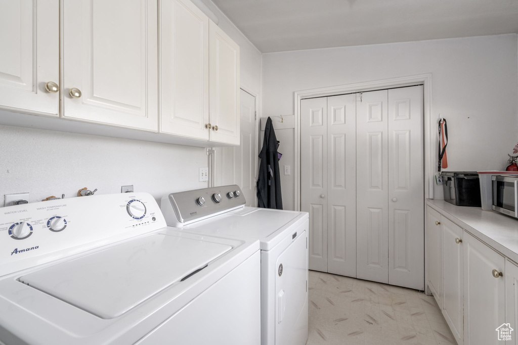 Laundry room with cabinet space and independent washer and dryer