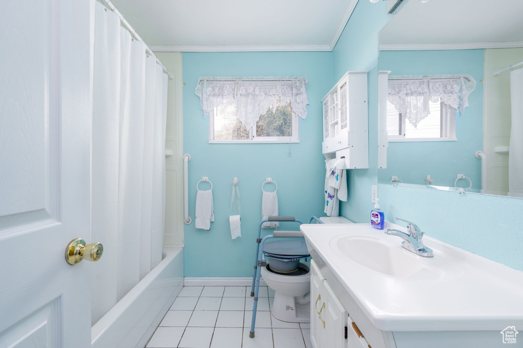 Full bath featuring vanity, tile patterned floors, toilet, baseboards, and ornamental molding