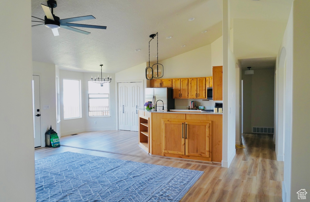 Kitchen with visible vents, stainless steel appliances, light countertops, and light wood finished floors