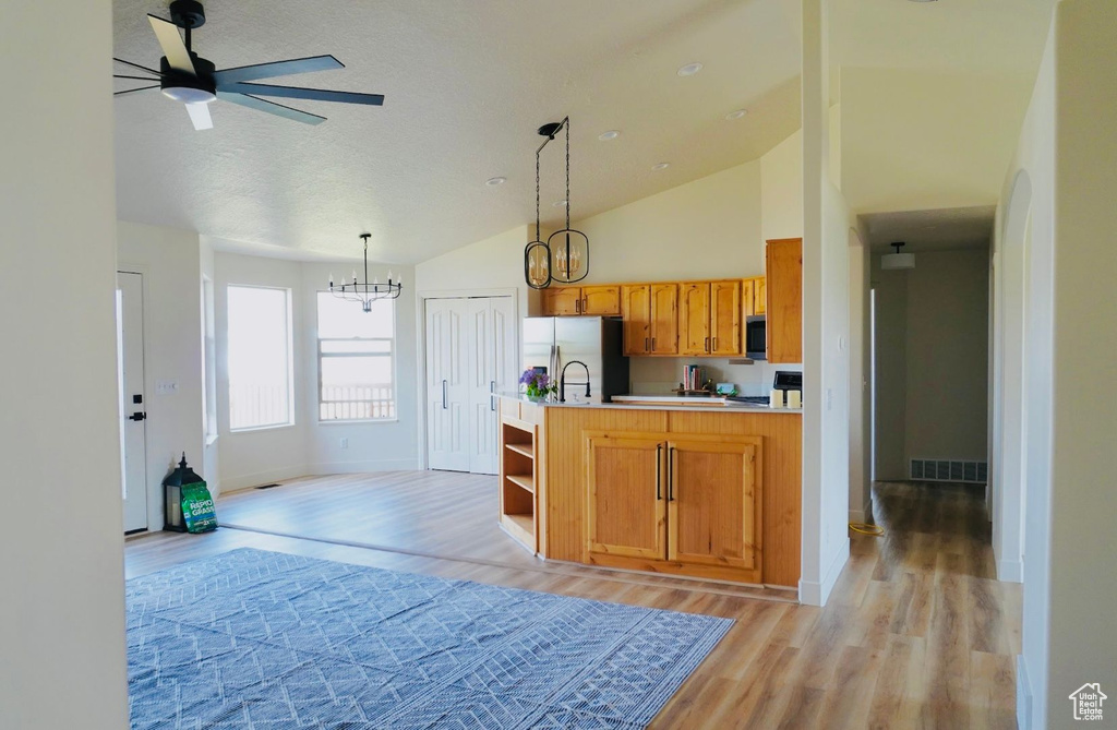 Kitchen featuring visible vents, light wood-style floors, appliances with stainless steel finishes, and light countertops