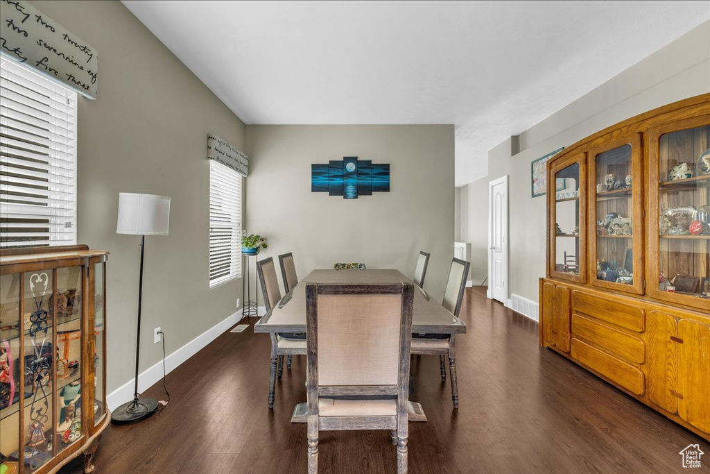 Dining room featuring baseboards and dark wood-type flooring