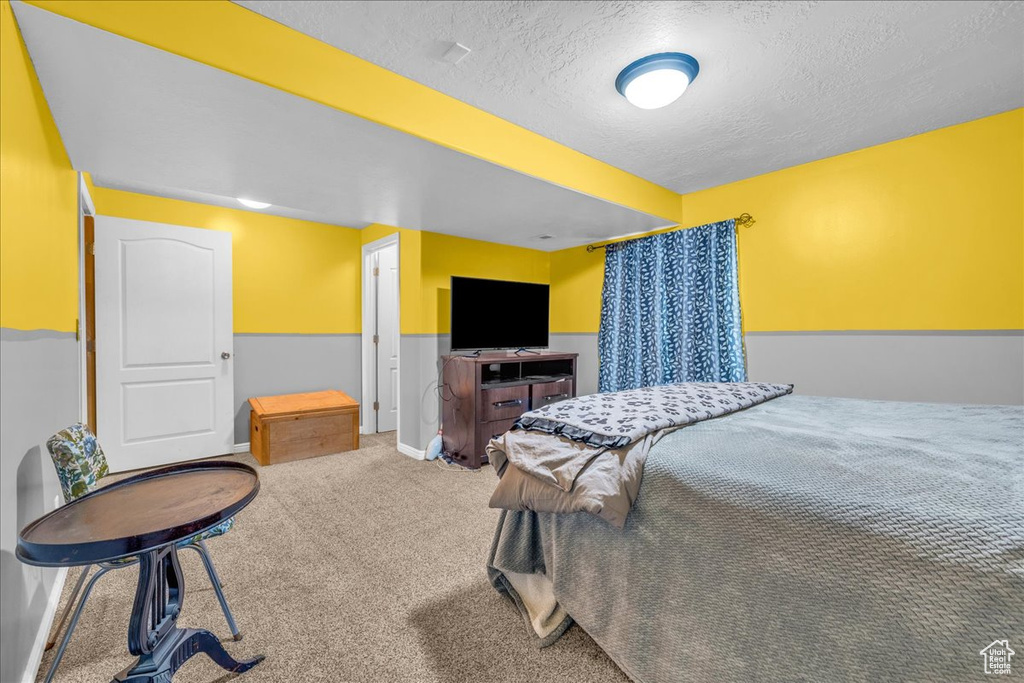 Bedroom featuring a textured ceiling and carpet floors