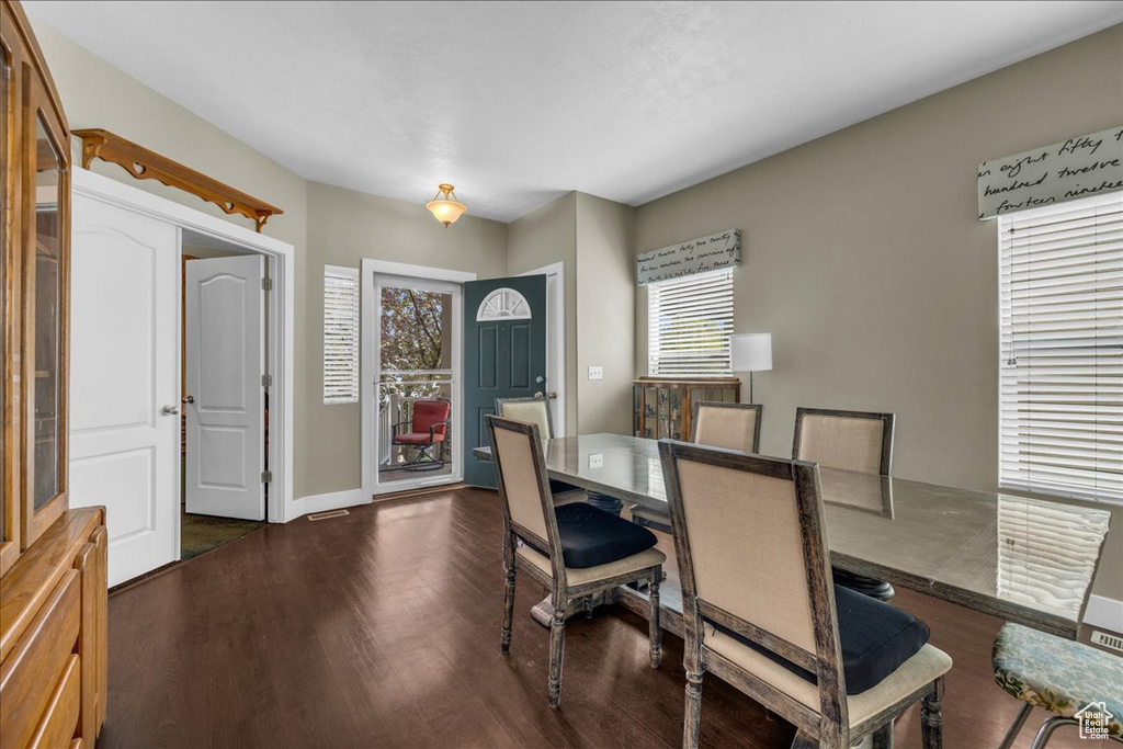 Dining room featuring baseboards and dark wood-type flooring