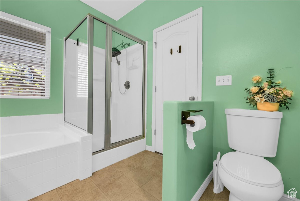 Full bath featuring toilet, a stall shower, and a bath