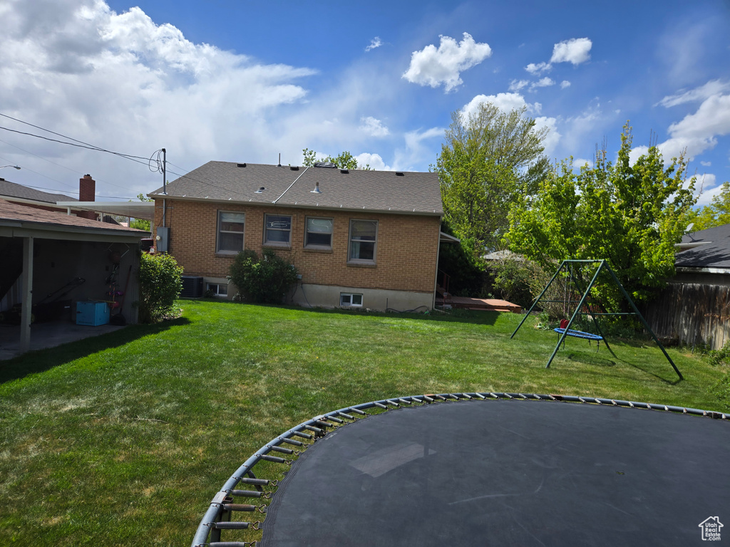 View of yard with fence and central AC