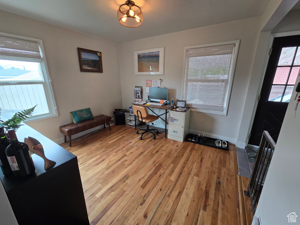 Home office featuring light wood-type flooring and baseboards
