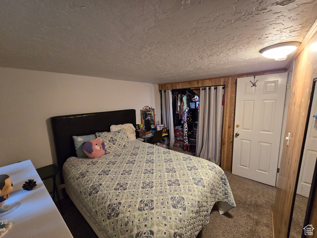 Carpeted bedroom with a textured ceiling