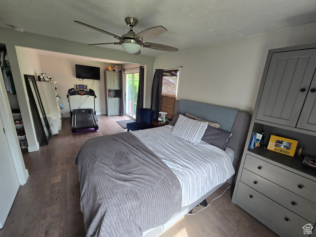 Bedroom featuring baseboards, a ceiling fan, wood finished floors, and access to outside