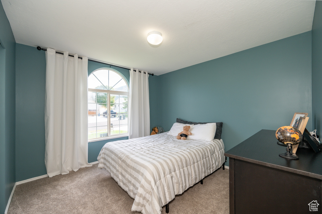 Carpeted bedroom featuring baseboards