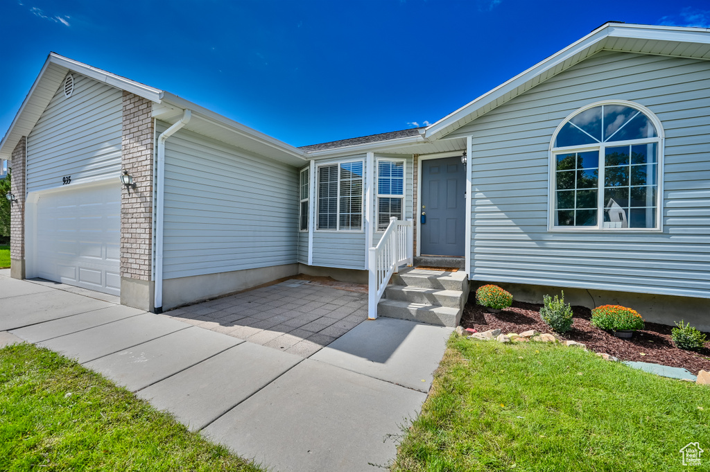 View of front of house featuring a front yard and an attached garage